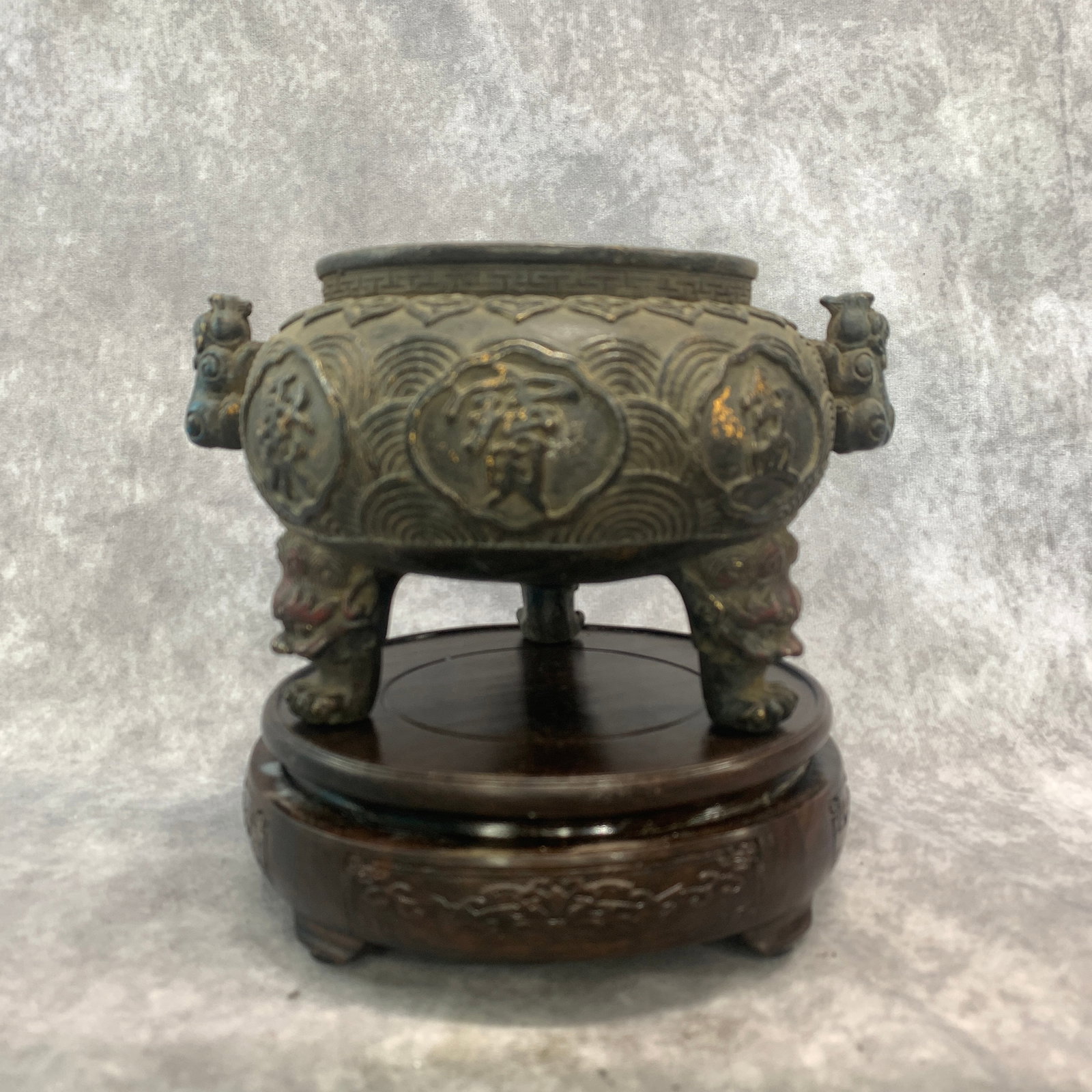 A CHINESE PARCEL-GILT AND POLYCHROME BRONZE 'AUSPICIOUS CHARACTER' TRIPOD INCENSE BURNER: Republic Period; Long: 7.6 inch; Width:6.3 inch; High: 4.6 inch; wooden base for picture and display purpose only.