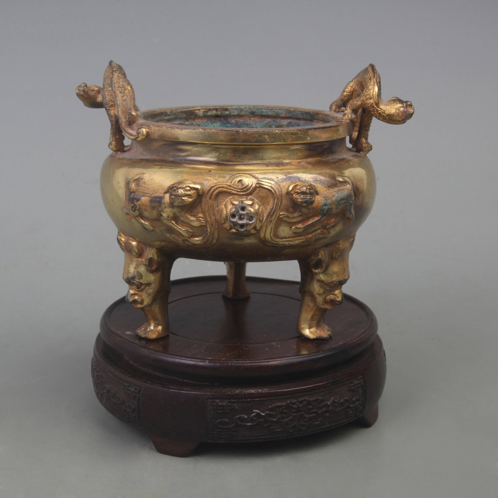 BRONZE GILT INCENSE BURNER WITH BEAST-SHAPED EARS: Qing Dynasty; Diameter: 8.0 inch; High: 4.8 inch; wooden base for picture and display purpose only.