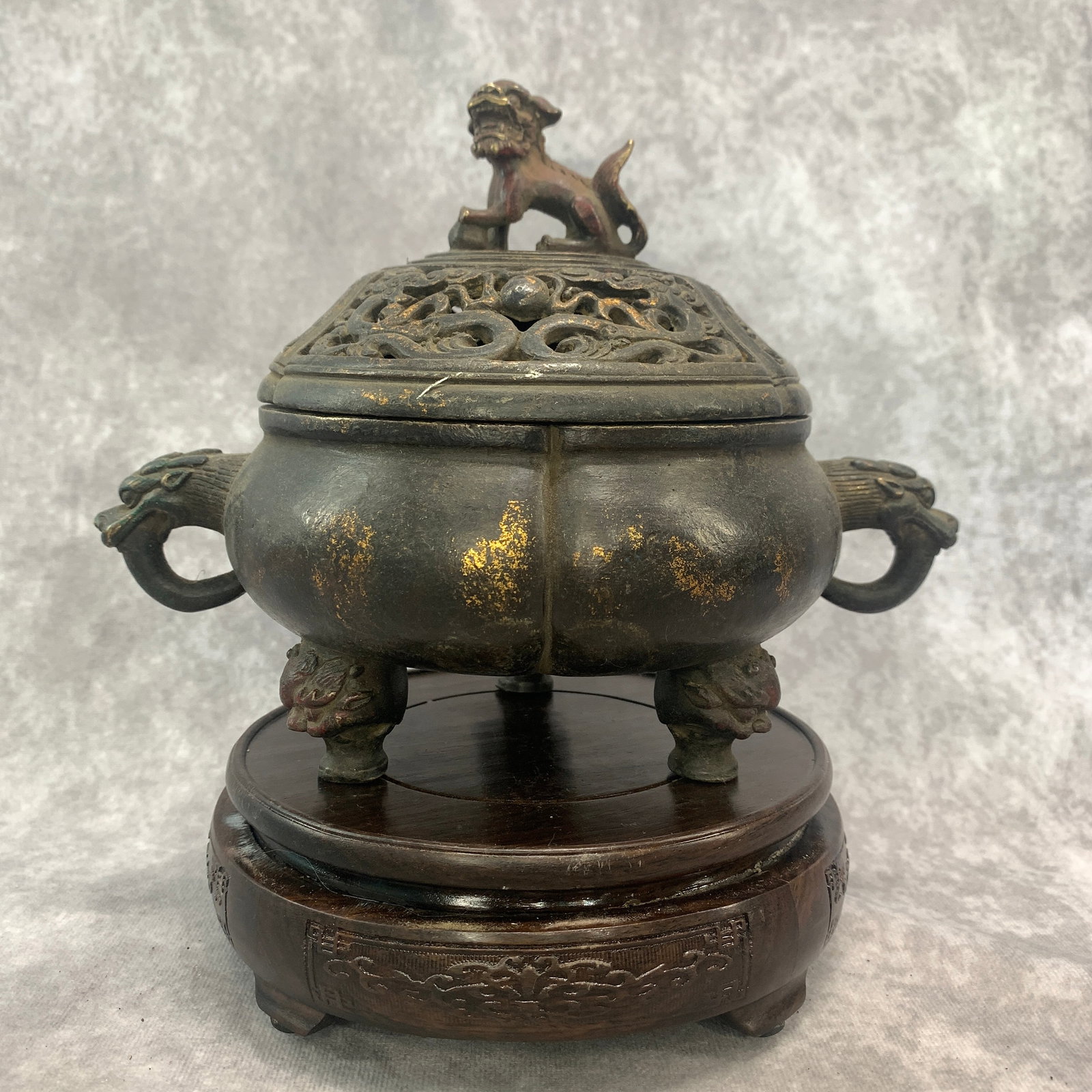 A CHINESE PARCEL-GILT AND POLYCHROME BRONZE 'BUDDHIST LION' TRIPOD INCENSE BURNER AND COVER: Qing Dynasty; Long: 8.8 inch; Width:6 inch; High: 6.6 inch; wooden base for picture and display purpose only.