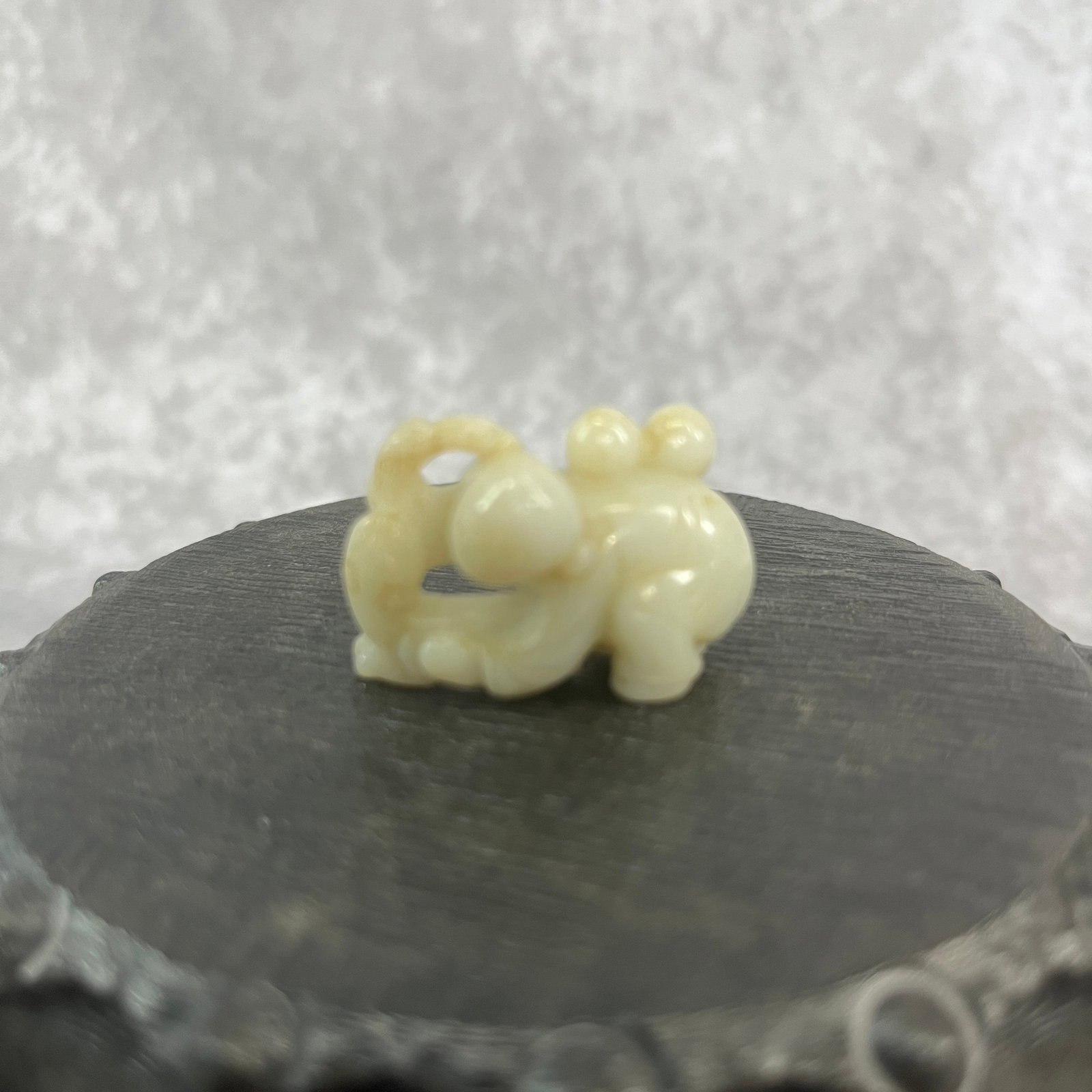 A FINE HAND CARVED HETIAN JADE PENDANT WITH PLAYING BOY FIGURE: Qing Dynasty; Long: 1.38 inch; Width: 0.91 inch; High: 0.72 inch; wooden base for picture and display purpose only.