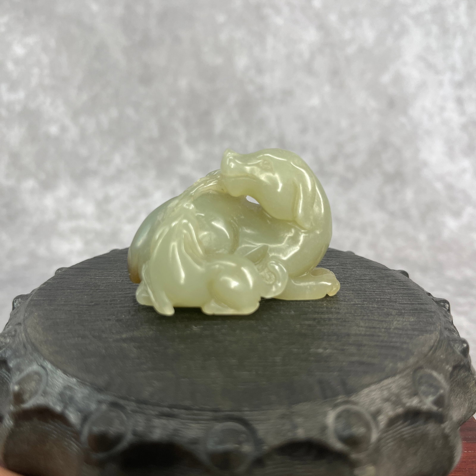 A FINE HETIAN JADE IN FIGURE OF TWO FU DOG: Qing Dynasty; Long: 2 inch; Width: 1.2 inch; High: 1.32 inch; wooden base for picture and display purpose only.