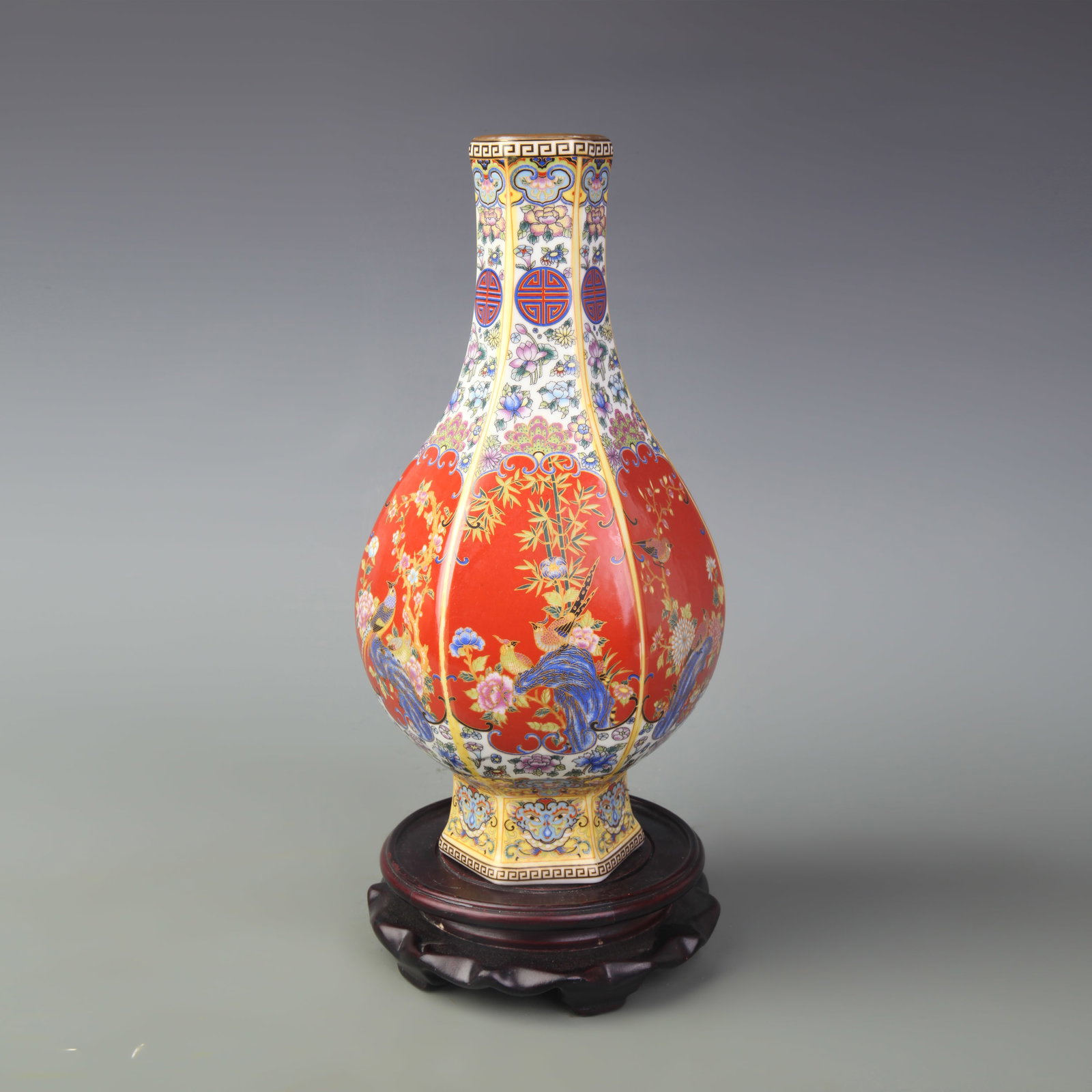 AN ENAMELLED FLORAL AND BIRD HEXAGONAL PORCELAIN VASE: Qing Dynasty Yong Zheng Period; High: 10.0 inch; wooden base for picture and display purpose only.