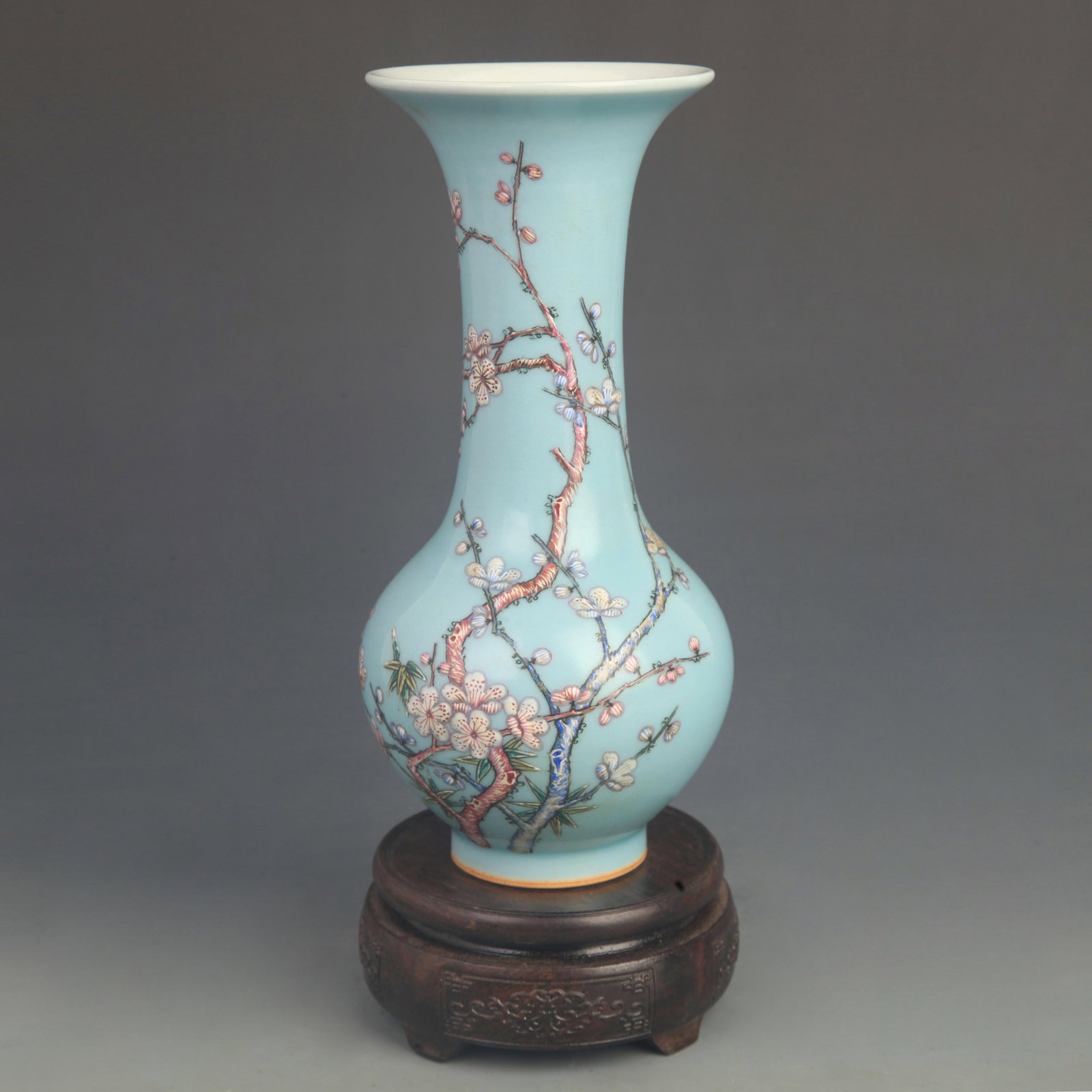 FAMILLE ROSE BLUE GROUND PLUM PATTERN LONG NECKED PORCELAIN VASE: Qing Dynasty Qianlong Period; High: 9.80 inch; Diameter: 4.00 inch; wooden base for picture and display purpose only.