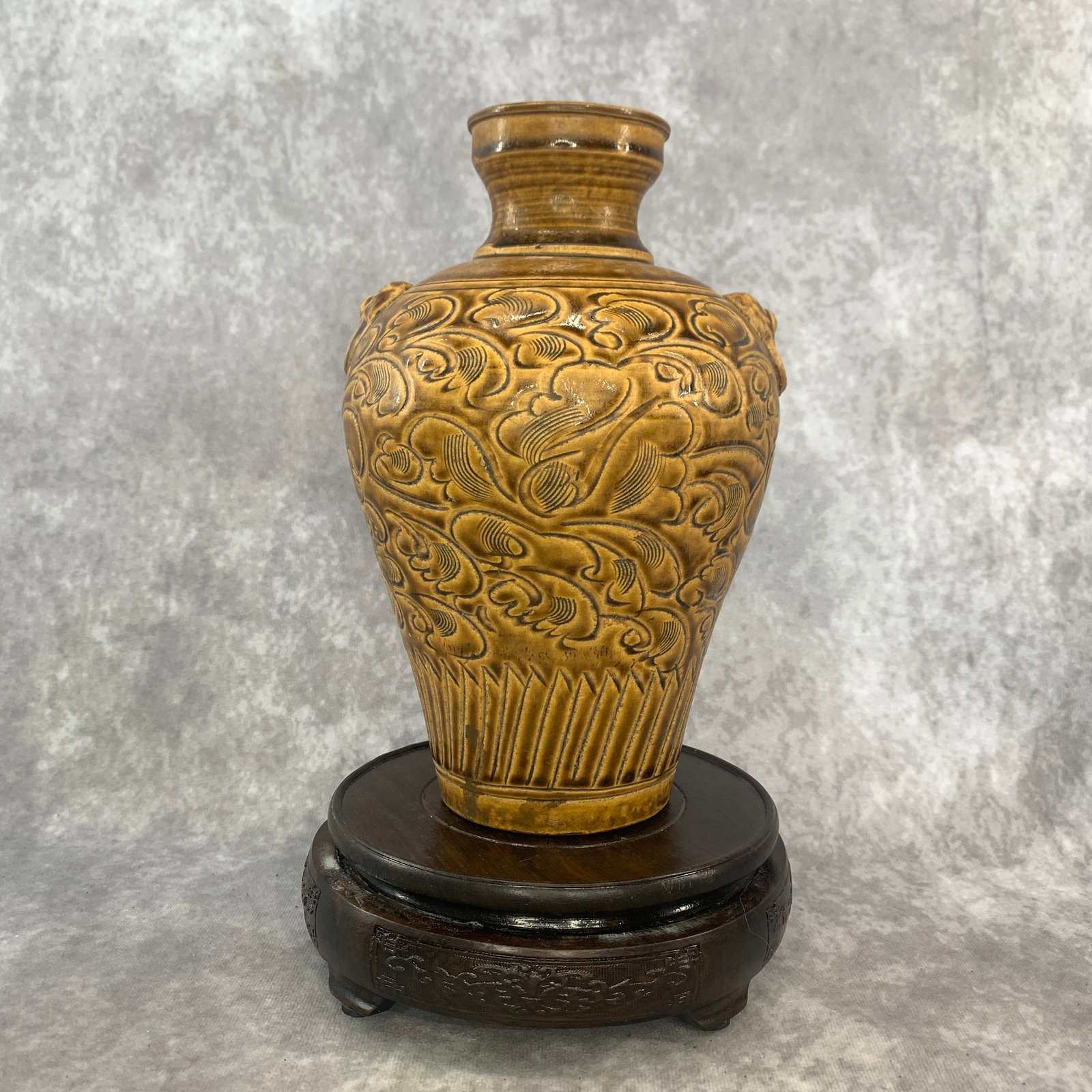 A FINE CIZHOU KILN CARVED OCHRE-GLAZED STONEWARE VASE: Song Dynasty Style; High: 8.9 inch; Diameter: 5.7 inch; wooden base for picture and display purpose only.
