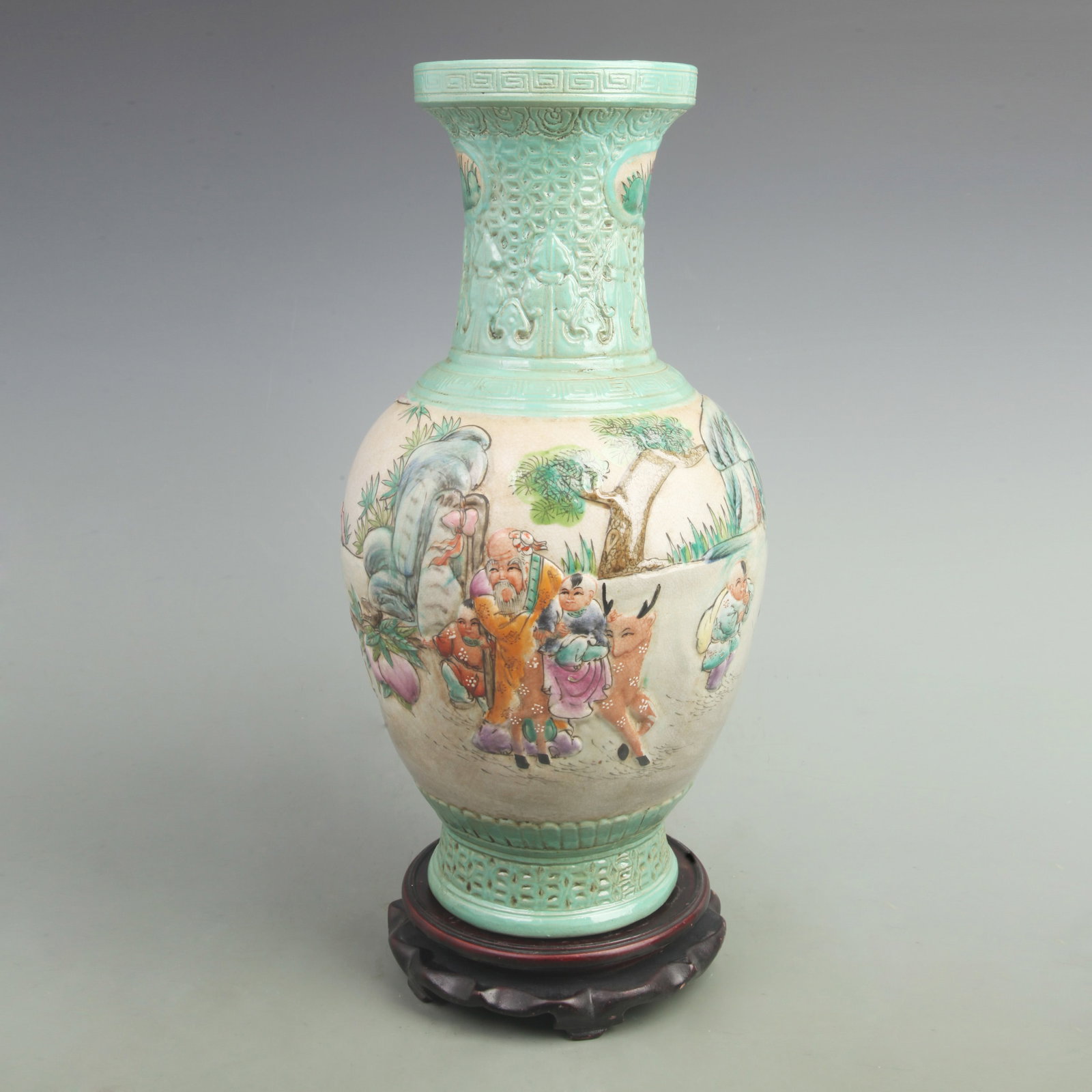 FAMILLE ROSE CARVED VASE WITH BOYS PRESENTING LONGEVITY: Qing Dynasty Qian Long Period; High: 16.8 inch; Width: 9.5 inch; wooden base for picture and display purpose only.
