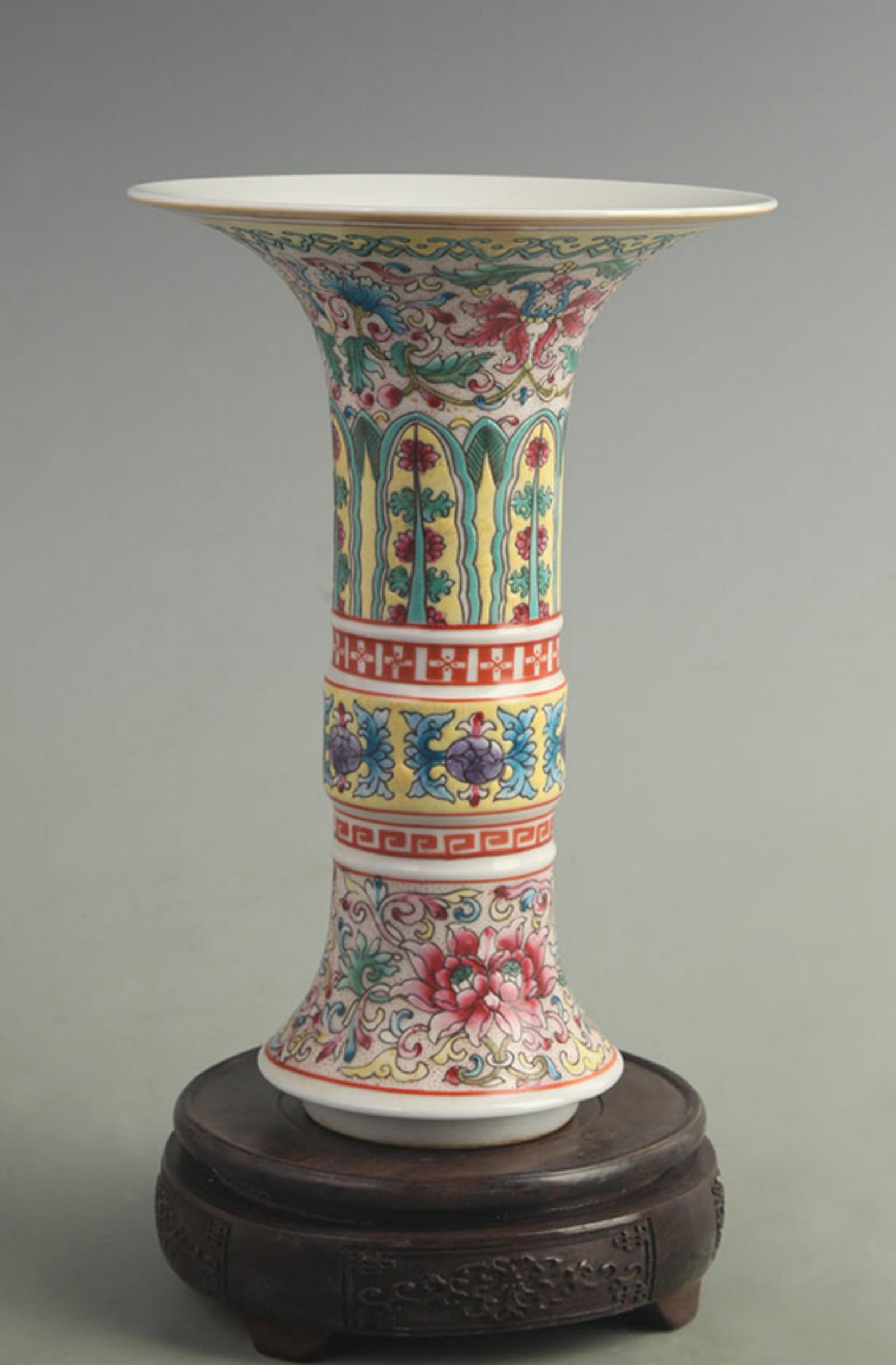 AN ENAMELLED AND GILT FLORAL GU VASE: Qing Dynasty Qian Long Period; High: 9.00 inch; Diameter: 6.10 inch; wooden base for picture and display purpose only.