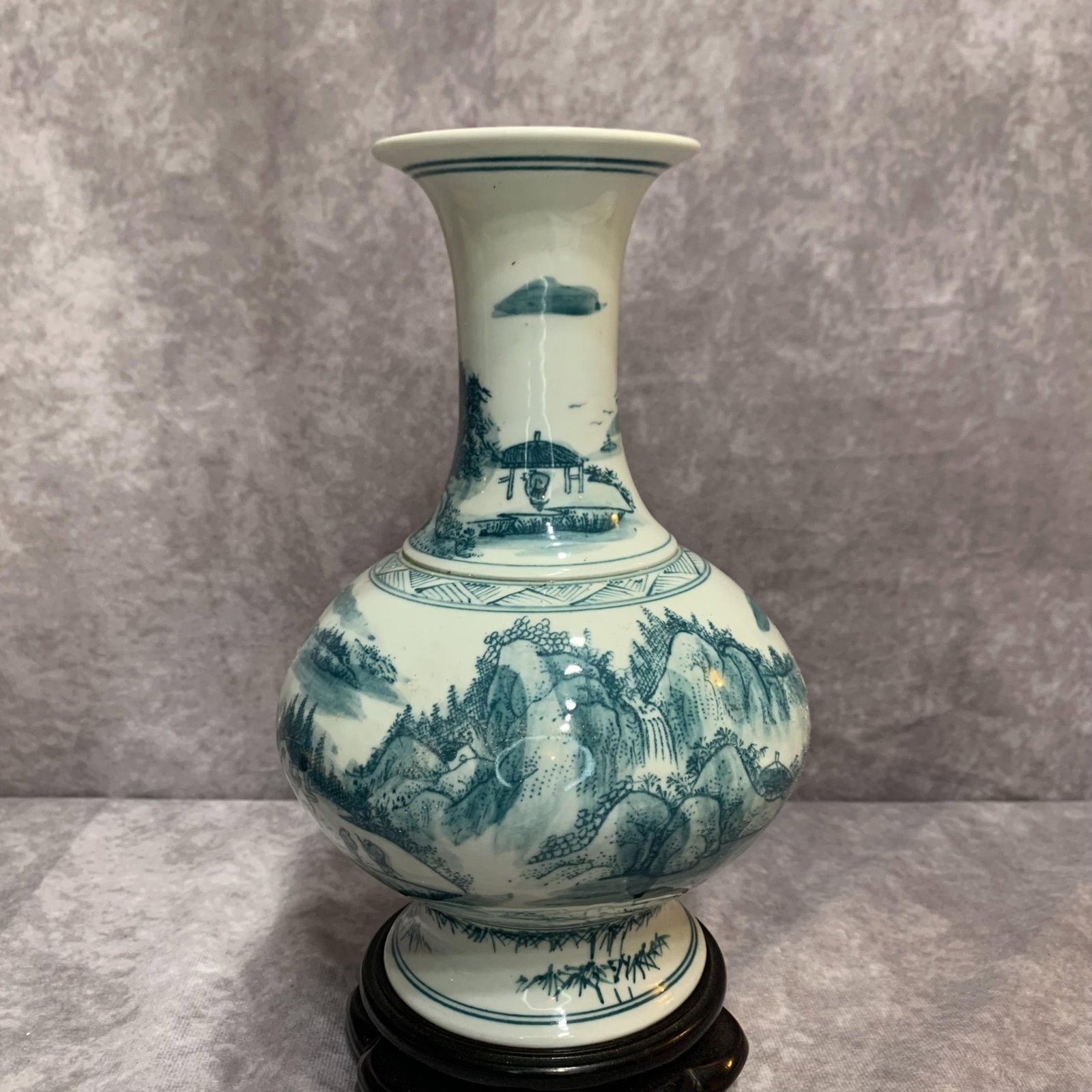 A GREEN ENAMEL LANDSCAPING PAINTED PORCELAIN VASE: 19th Century; High: 8.7 inch; Diameter: 5.5 inch; wooden base for picture and display purpose only.