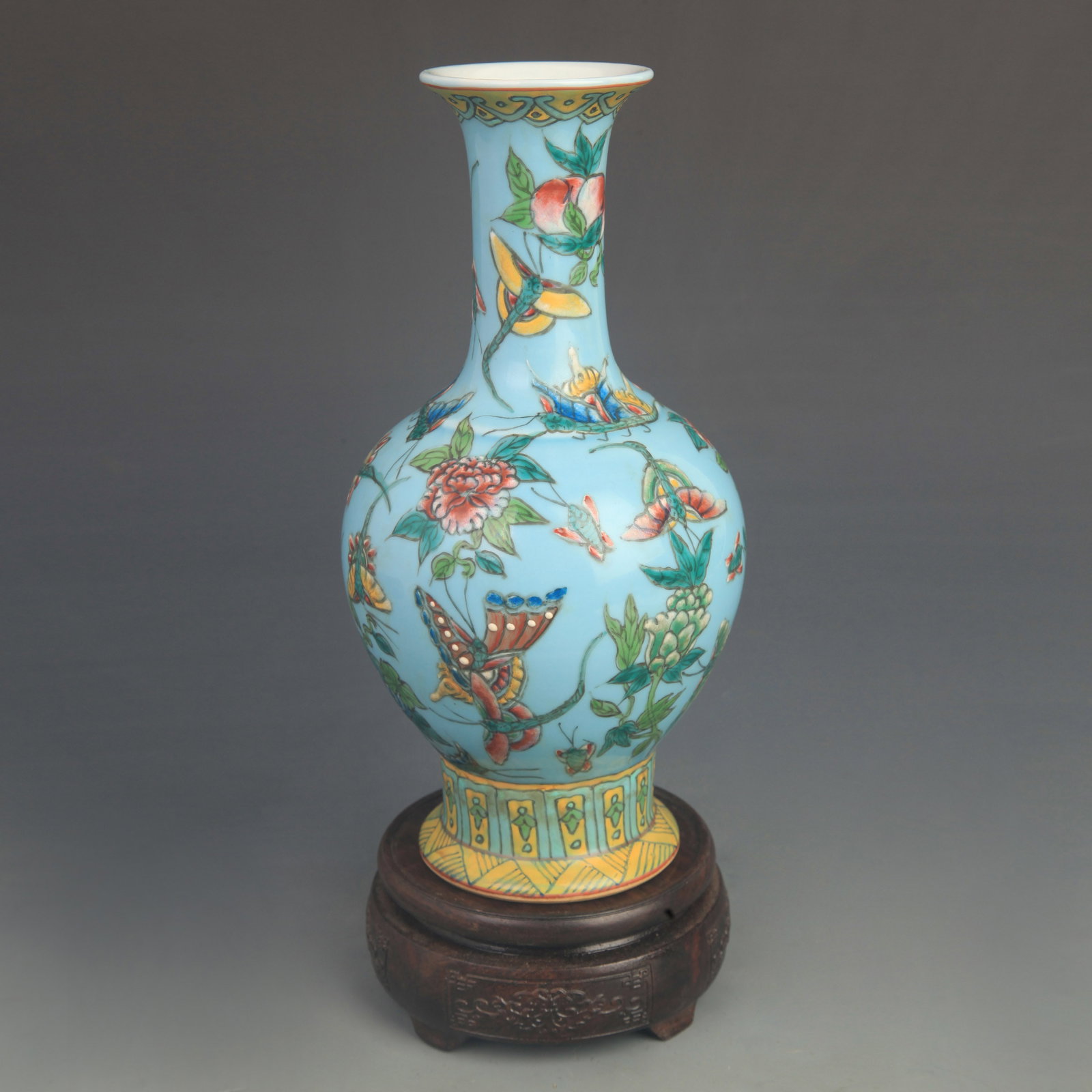 FAMILLE ROSE ORCHID GROUND BUTTERFLY PORCELAIN VASE: Qing Dynasty Qian Long Period; High: 9.80 inch; Diameter:4.80 inch; wooden base for picture and display purpose only.