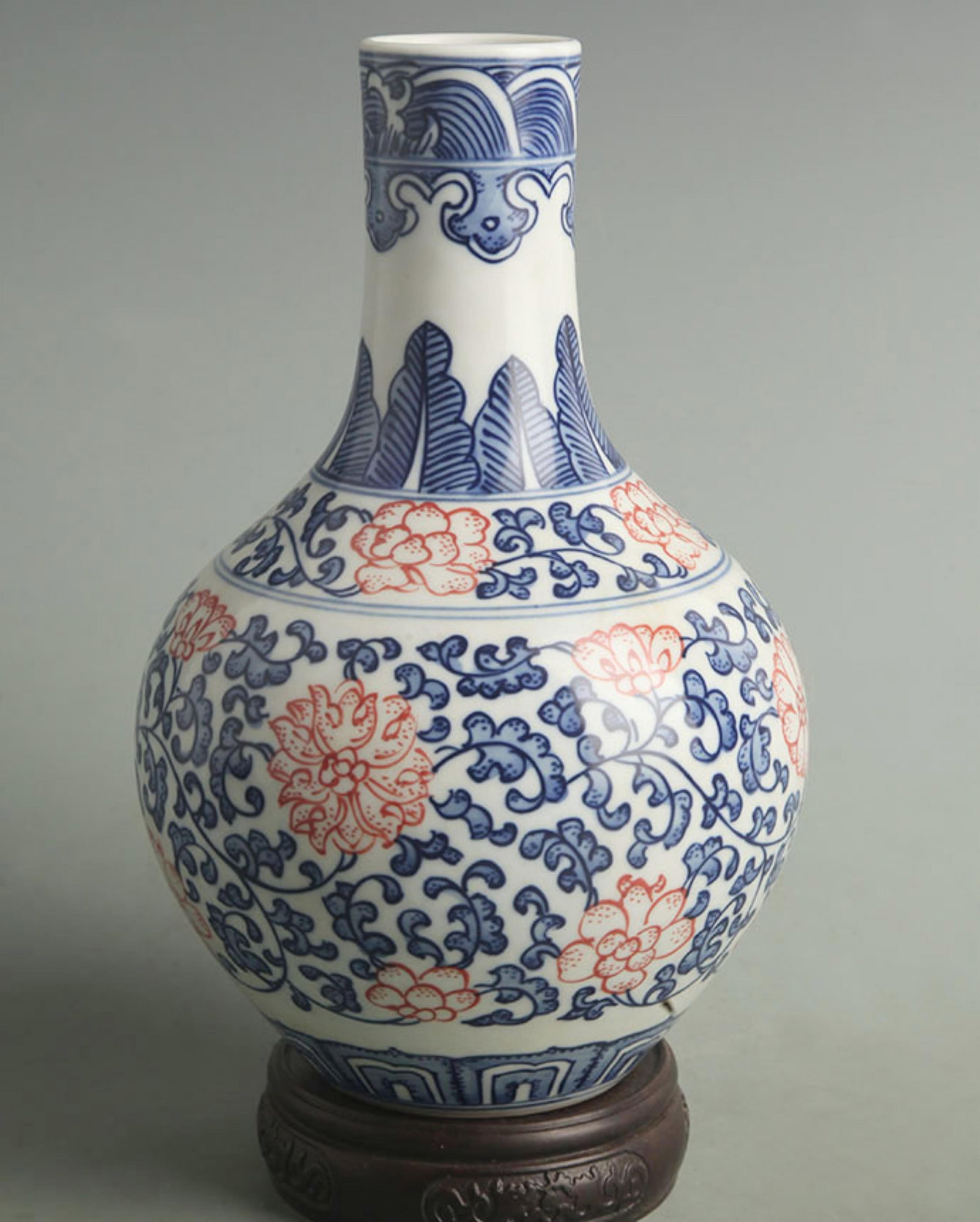 BLUE AND WHITE CELESTIAL VASE WITH UNDERGLAZE RED LOTUS SCROLLS: Qing Dynasty Qian Long Period: High: 8.50 inch; Width: 5.50 inch;; wooden base for picture and display purpose only.