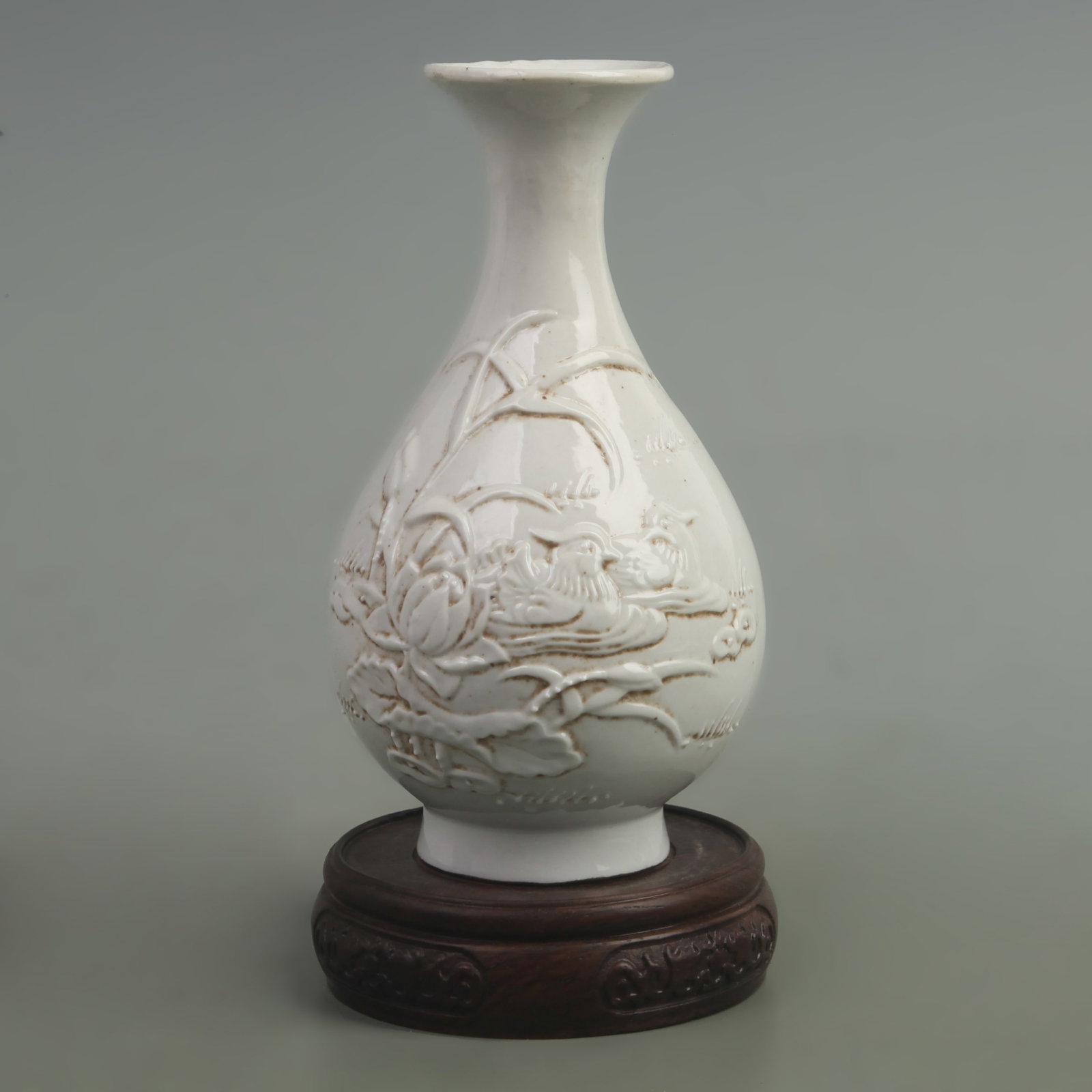 A LOTUS FLOWER CARVING PORCELAIN YU HU CHUN STYLE BOTTLE: Qing Dynasty Qian Long Period, High: 6.8 inch; Width: 4 inch; wooden base for picture and display purpose only.