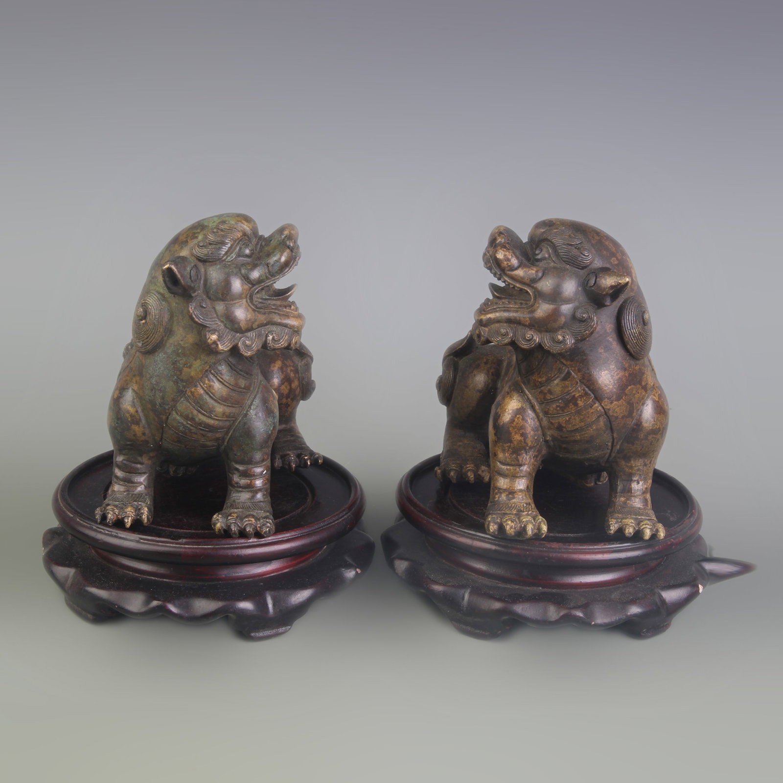 A PAIR OF BRONZE LION ORNAMENTS: Qing Dynasty; Long: 4.9 inch; High: 4.3 inch; wooden base for picture and display purpose only.