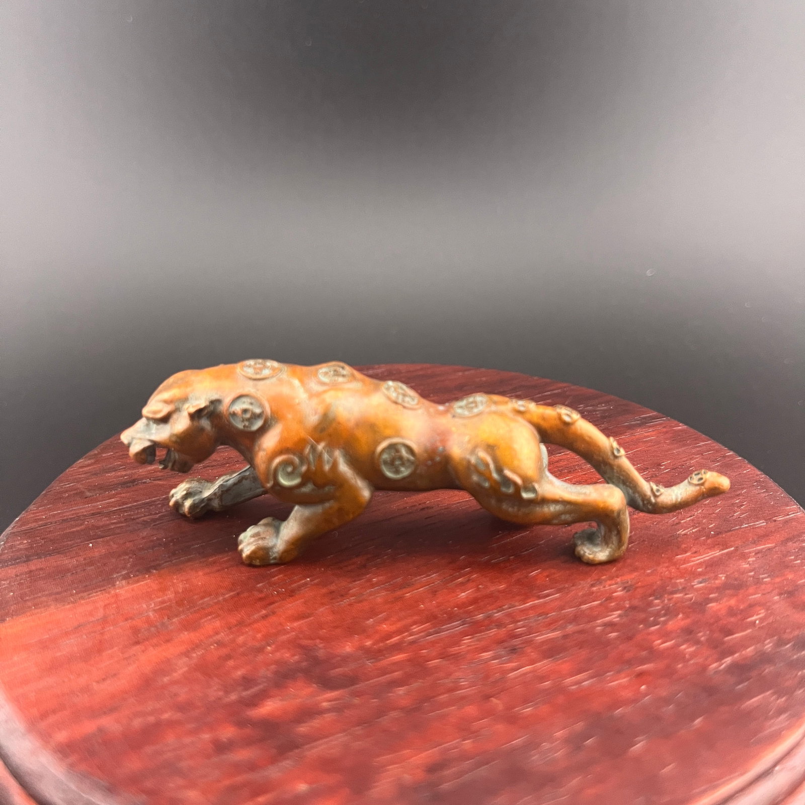 A SMALL BRONZE FIGURINE OF A CROUCHING MYTHICAL BEAST: Modern; Long: 3.4 inch; Width: 0.8 inch; High: 1.1 inch; wooden base for picture and display purpose only.