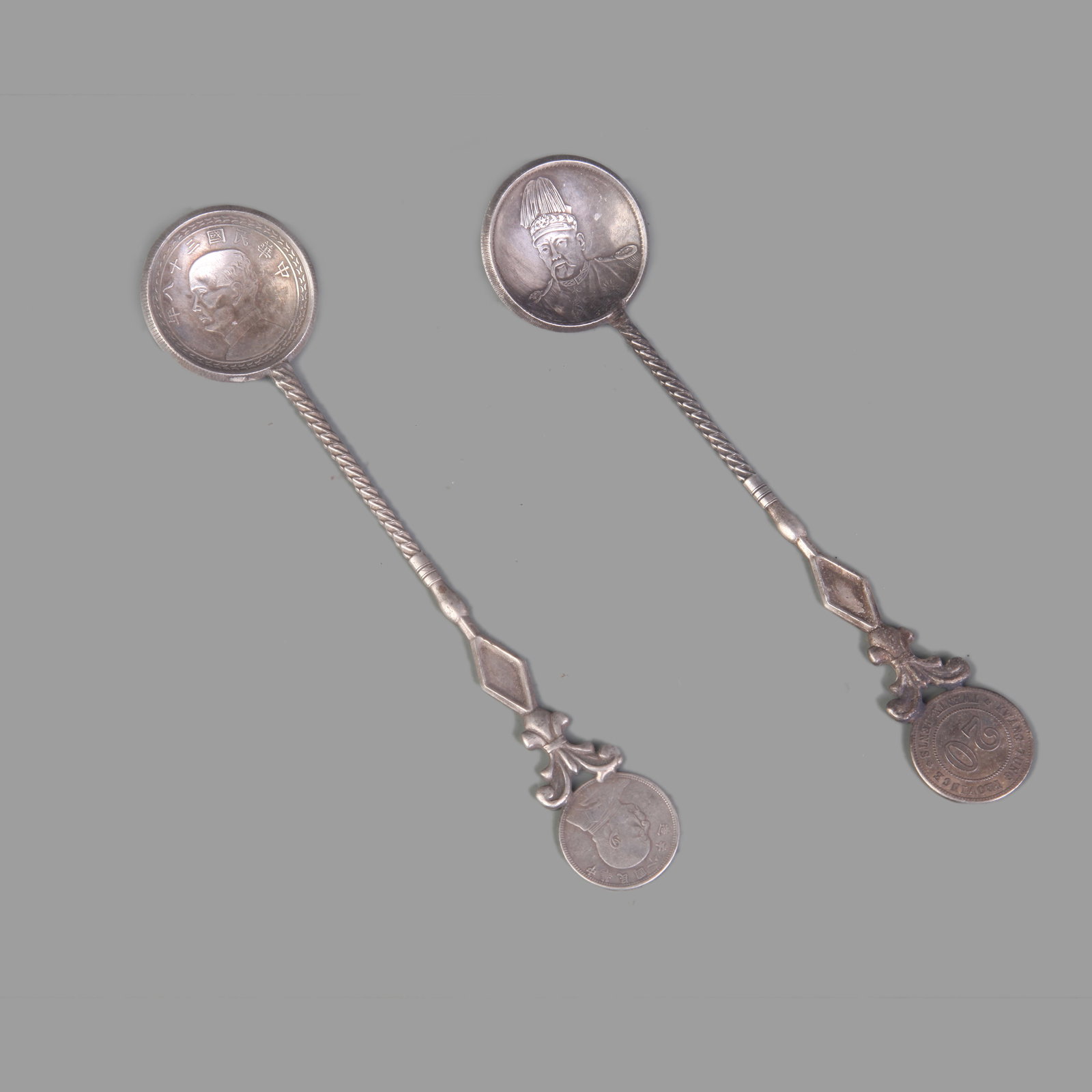 PAIR OF COIN STYLE SILVER PLATED SPOONS (1 of 9)