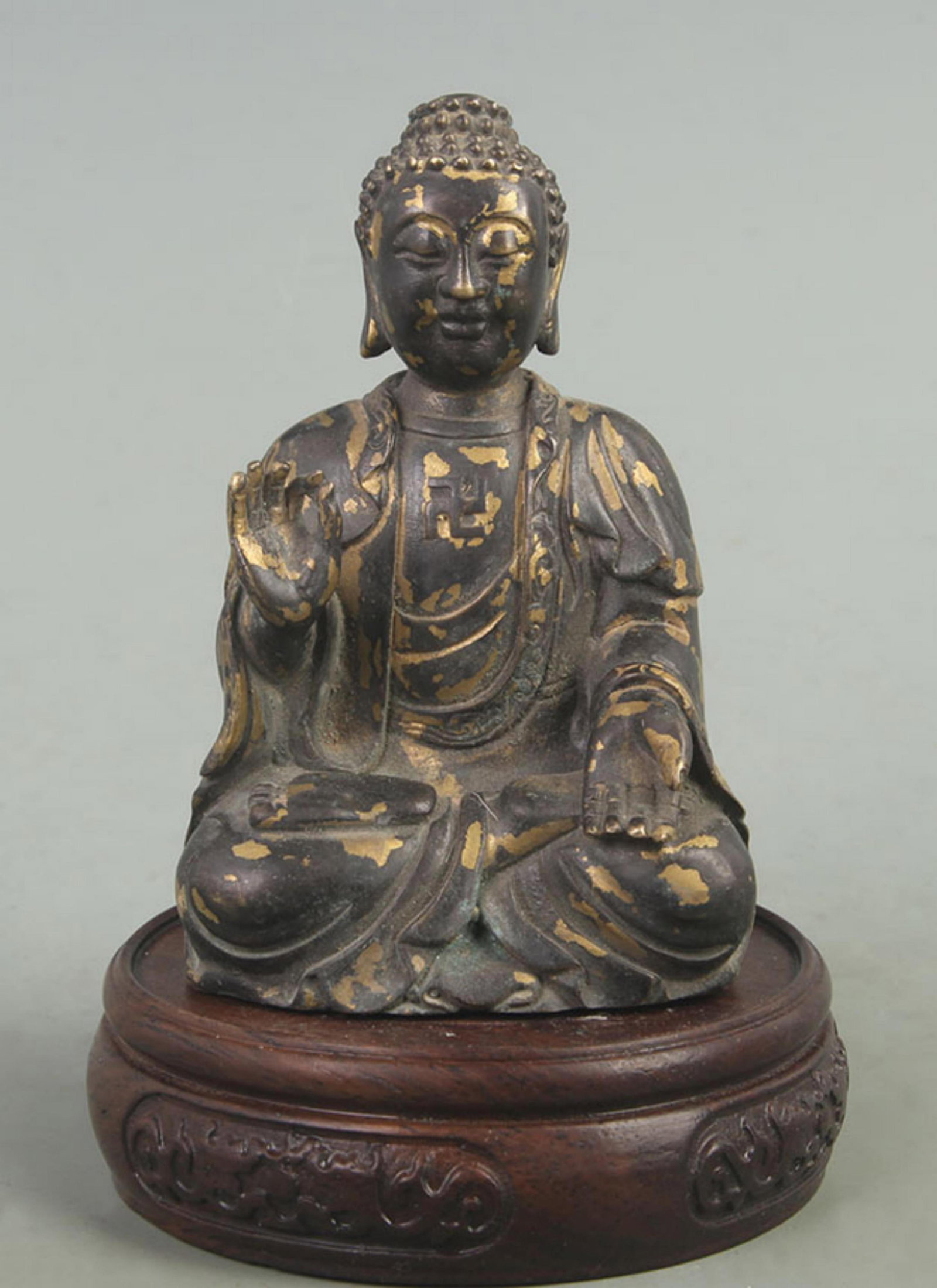 A FINE BRONZE GILT GAUTAMA BUDDHA: 20th Century; High: 4.40 inch; Width: 2.00 inch; Long: 2.80 inch; wooden base for picture and display purpose only.
