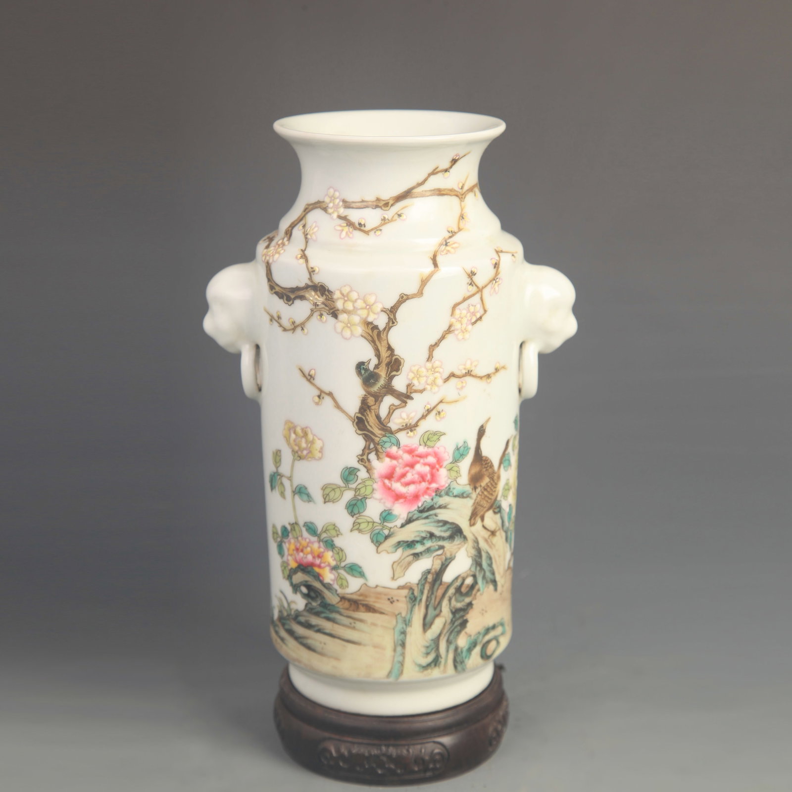 FAMILLE-ROSE BIRD-AND-FLOWER STRAIGHT-NECK VASE WITH LION-EARS: Qing Dynasty Qian Long Period; High: 9.30 inch; Diameter: 5.50 inch; wooden base for picture and display purpose only.