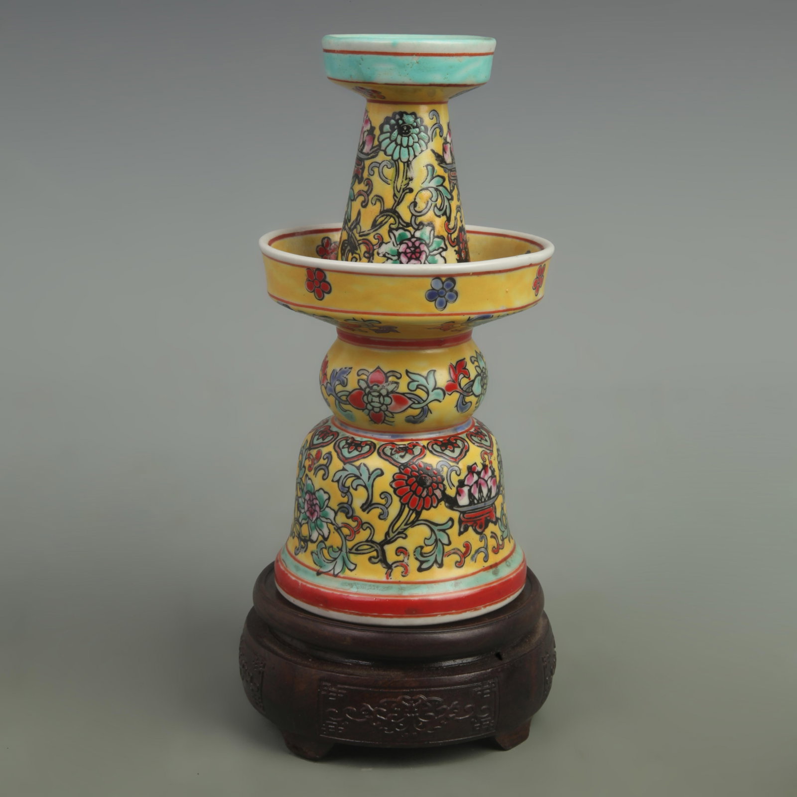 A FINE FAMILLE ROSE YELLOW GROUND PORCELAIN CANDLESTICKS: Qing Dynasty Qian Long Period; High: 8 inch; High: 4.5 inch; wooden base for picture and display purpose only.