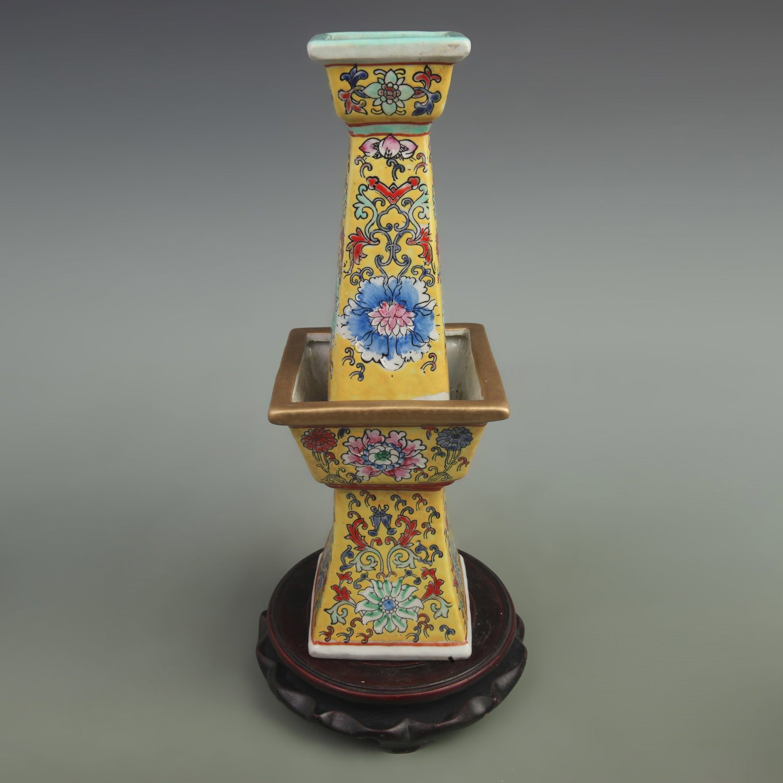 FAMILLE ROSE YELLOW GROUND FLOWER PATTERNED PORCELAIN CANDLE HOLDER: Qing Dynasty Yong Zheng Period; High:13.5 inch; Width: 4.8 inch; wooden base for picture and display purpose only.