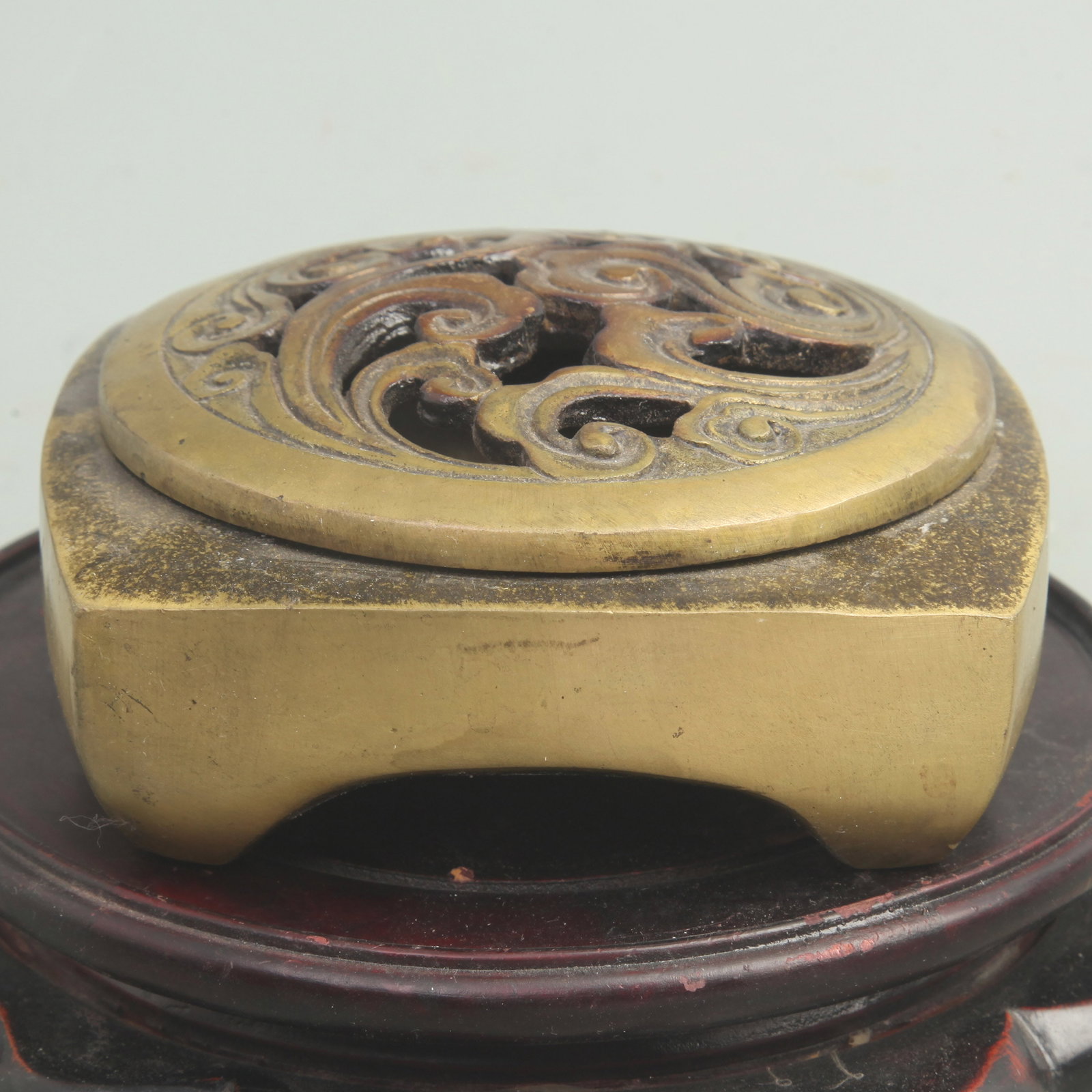 A FINE BRONZE FOUR-FOOTED INCENSE BURNER: Qing Dynasty; High: 1.5 inch; Width: 4.8 inch; wooden base for picture and display purpose only.