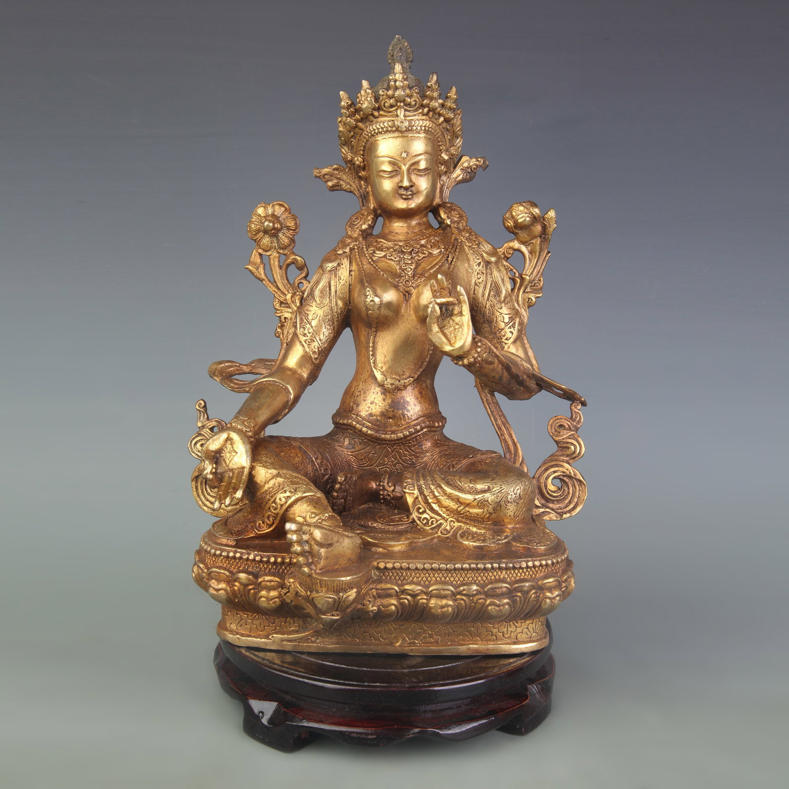 A GILT-BRONZE FIGURE OF GREEN TARA: Qing Dynasty; High: 11.9 inch; wooden base for picture and display purpose only.