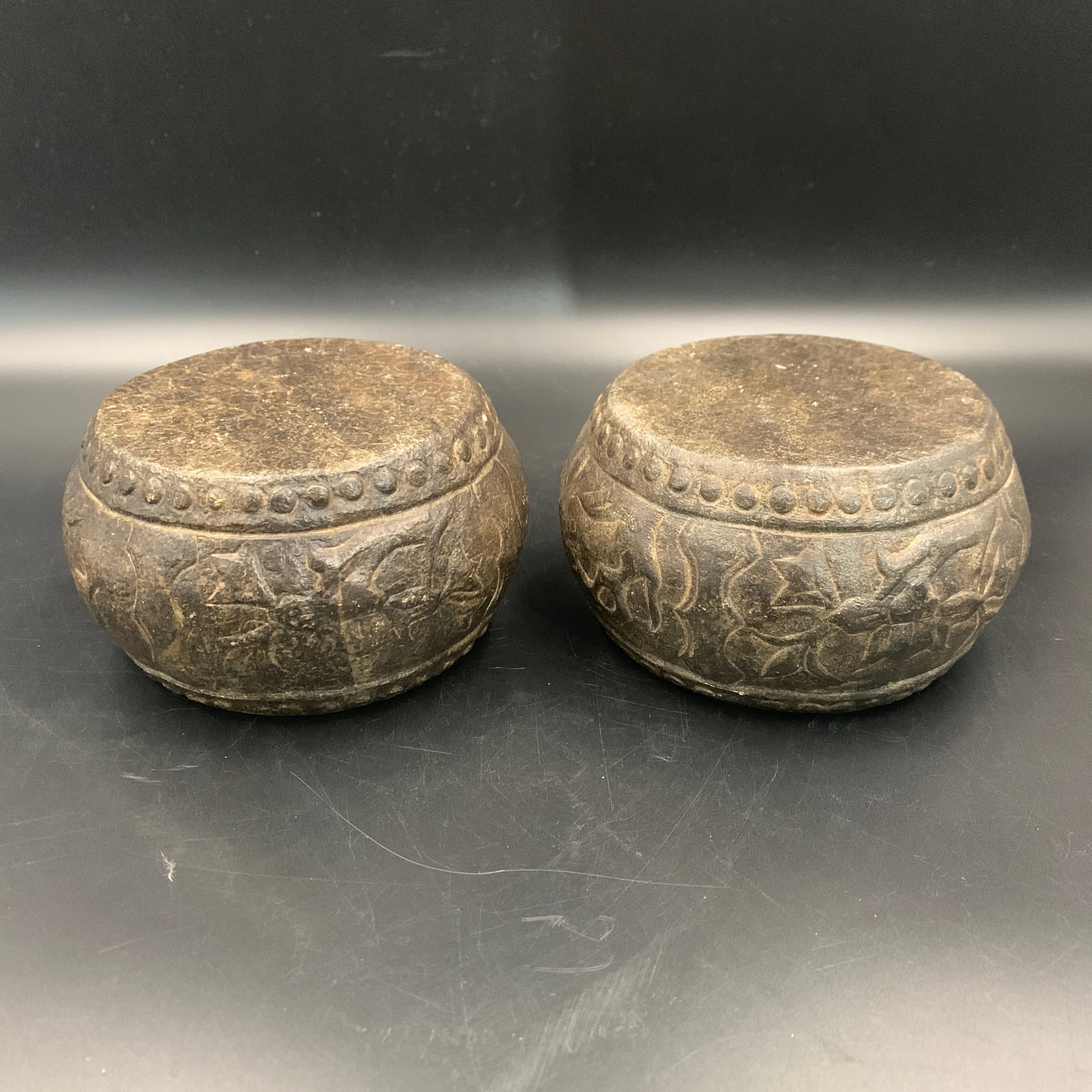 PAIR OF CARVED STONE CLOUD-SCROLL PATTERN BASES: Modern; High: 3.1 inch; Diameter: 5.5 inch;