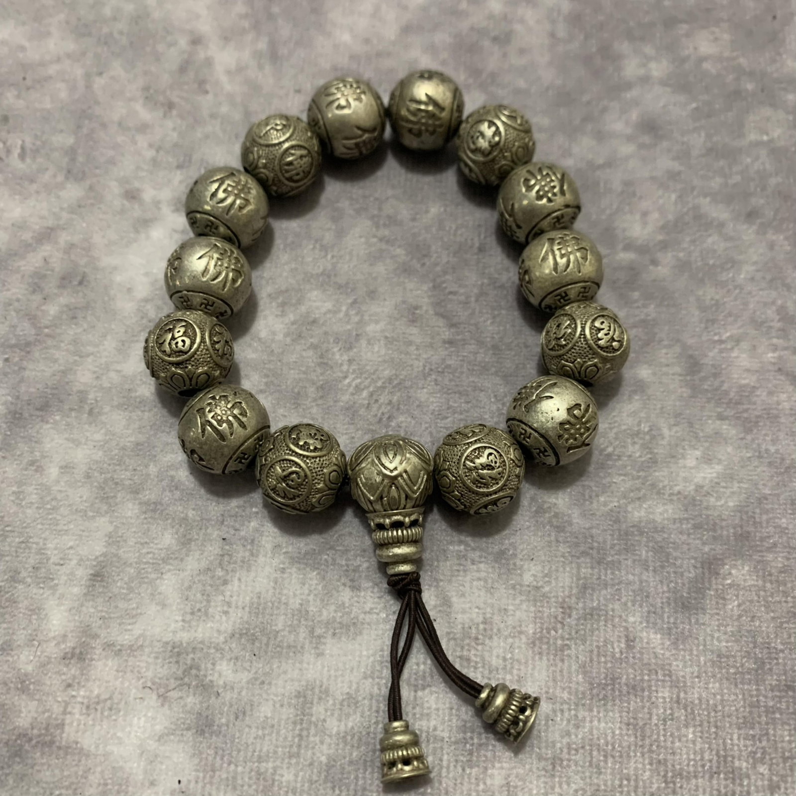 A FINE WHITE BRONZE BRACELETS: Modern; Long: 2.0 inch; Each Diameter: 0.5 inch; wooden base for picture and display purpose only.