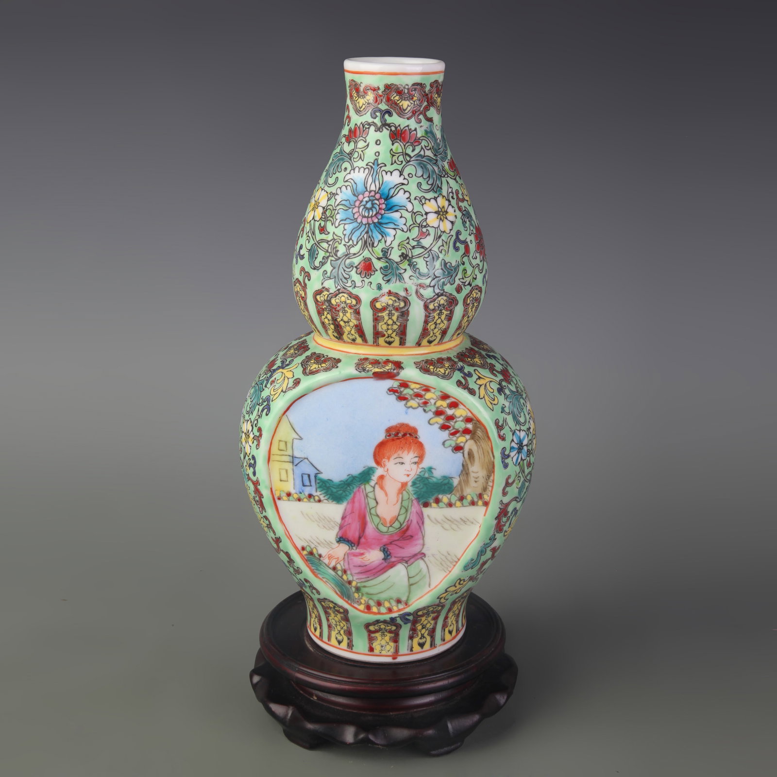 A CHINESE FAMILLE-ROSE LIGHT-GREEN GROUND 'LADIES AND LANDSCAPES' DOUBLE-GOURD VASE: Qing Dynasty Qian Long Period; Width: 5.3 inch; High: 10.9 inch; wooden base for picture and display purpose only.
