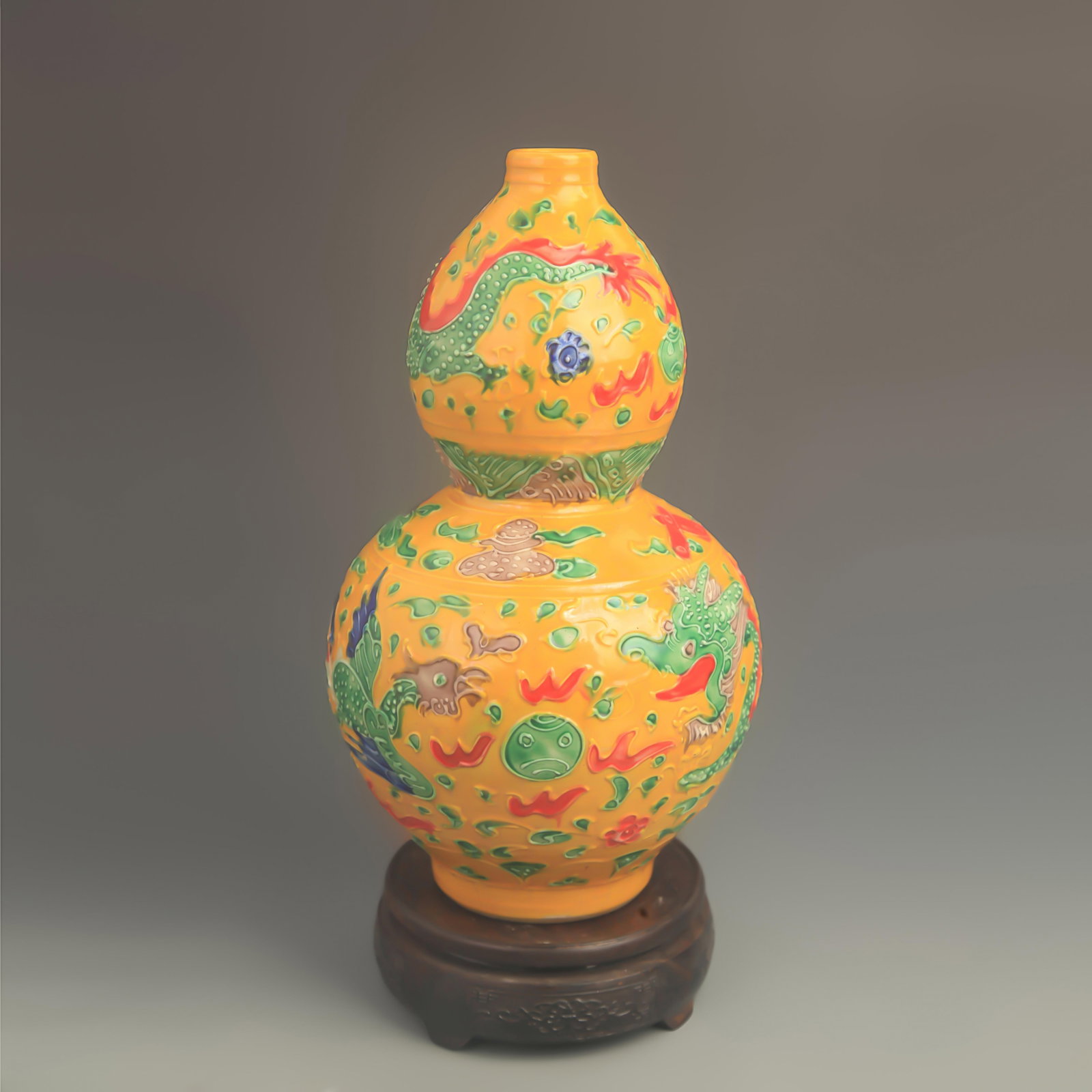 A FAHUA ENAMEL GOURD-SHAPED VASE WITH YELLOW GROUND: Ming Dynasty Hong Zhi Style; High: 11.5 inch; Diameter: 6.50 inch; wooden base for picture and display purpose only.