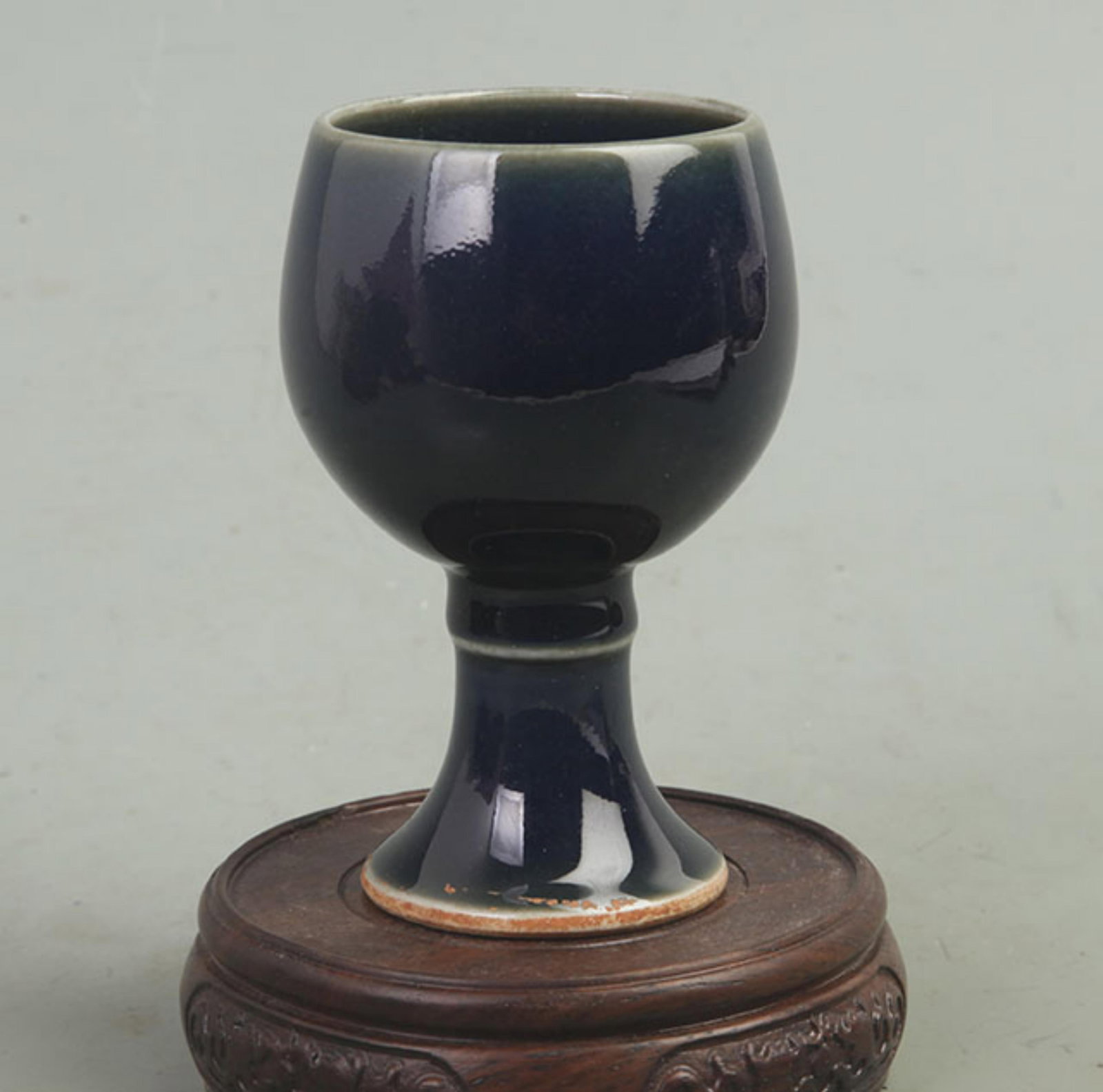 BLUE-GLAZED TALL-FOOTED PORCELAIN: Qing Dynasty, High: 4.0 inch; Diameter: 2.2 inch; wooden base for picture and display purpose only.