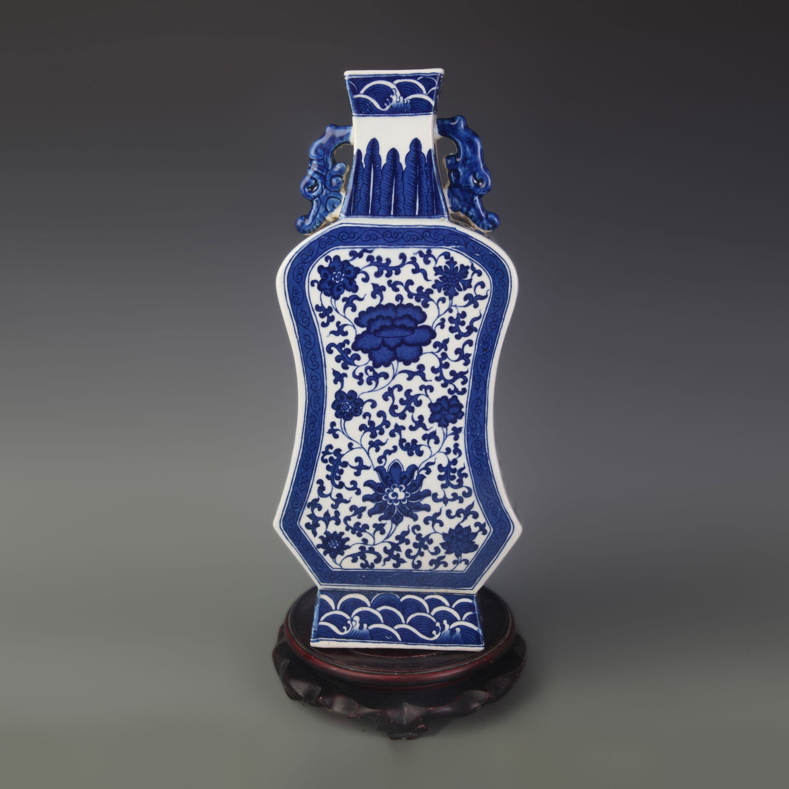 A BLUE AND WHITE FLORAL FAN-SHAPED VASE: Qing Dynasty Qian Long Period; Width: 6.4 inch; High: 14.8 inch; wooden base for picture and display purpose only.