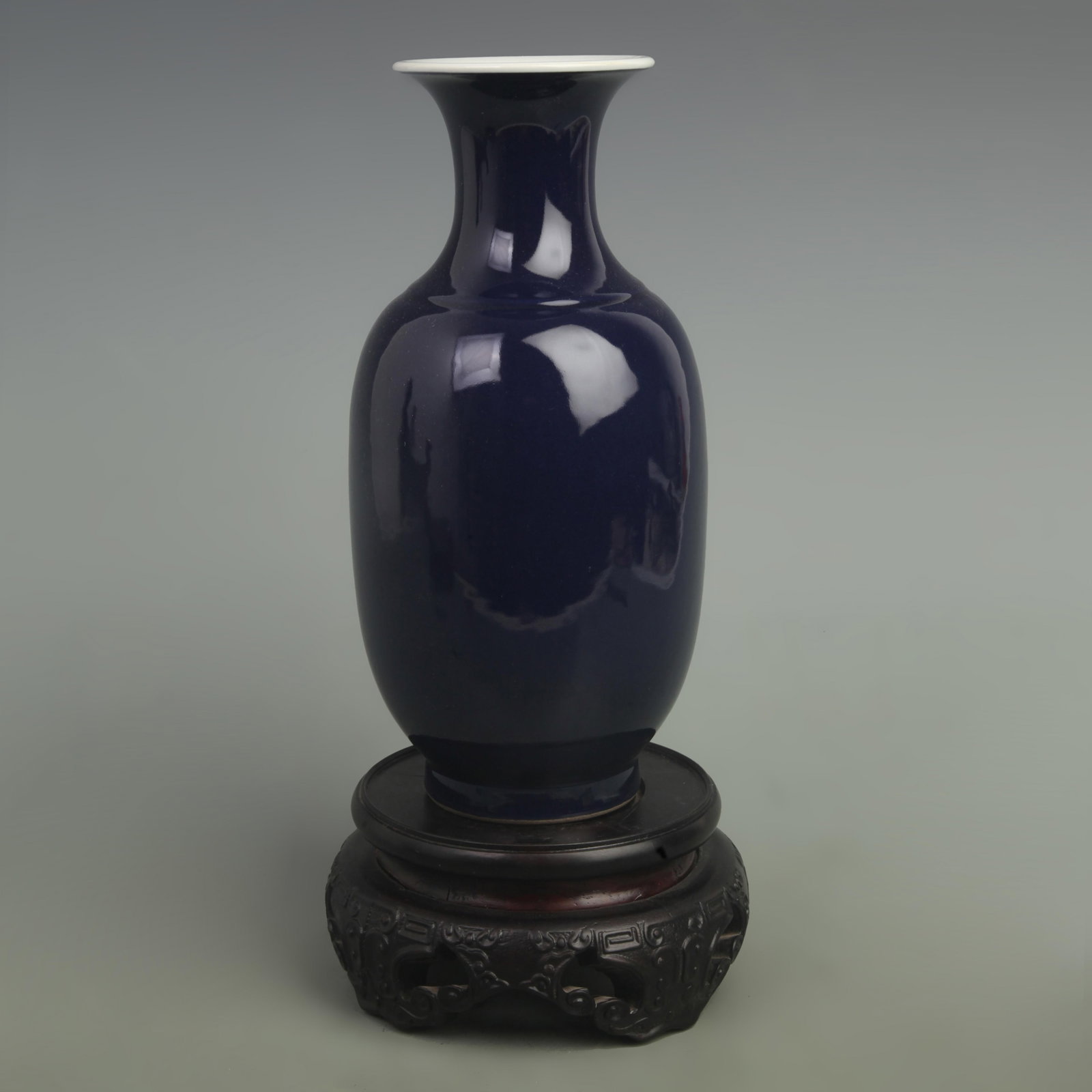 A FINE DARK BLUE GLAZE DONGGUA PORCELAIN VASE: Qing Dynasty; High: 9.5 inch; Width: 5.5 inch; wooden base for picture and display purpose only.