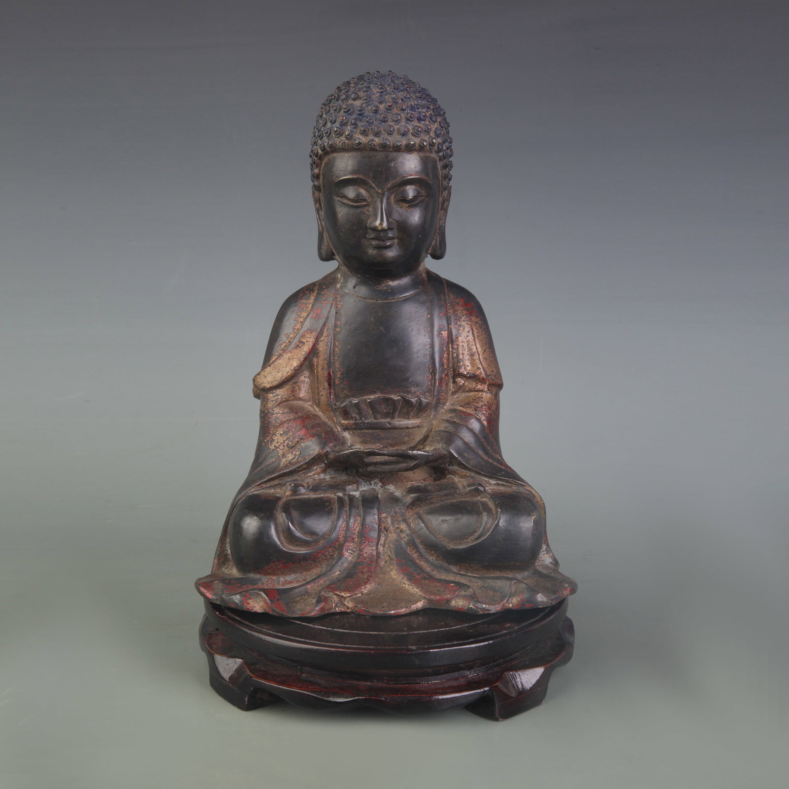 A FIGURE OF BRONZE SHAKYAMUNI BUDDHA: Qing Dynasty; Width: 6.8 inch; High: 9.4 inch; wooden base for picture and display purpose only.