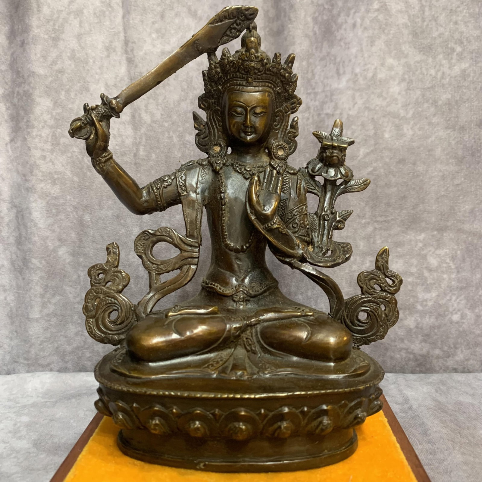 A FINE BRONZE MANJUSHRI BODHISATTVA STATUE: Qing Dynasty, High: 8.0 inch; Width: 6.1 inch; Long: 3.4 inch; wooden base for picture and display purpose only.