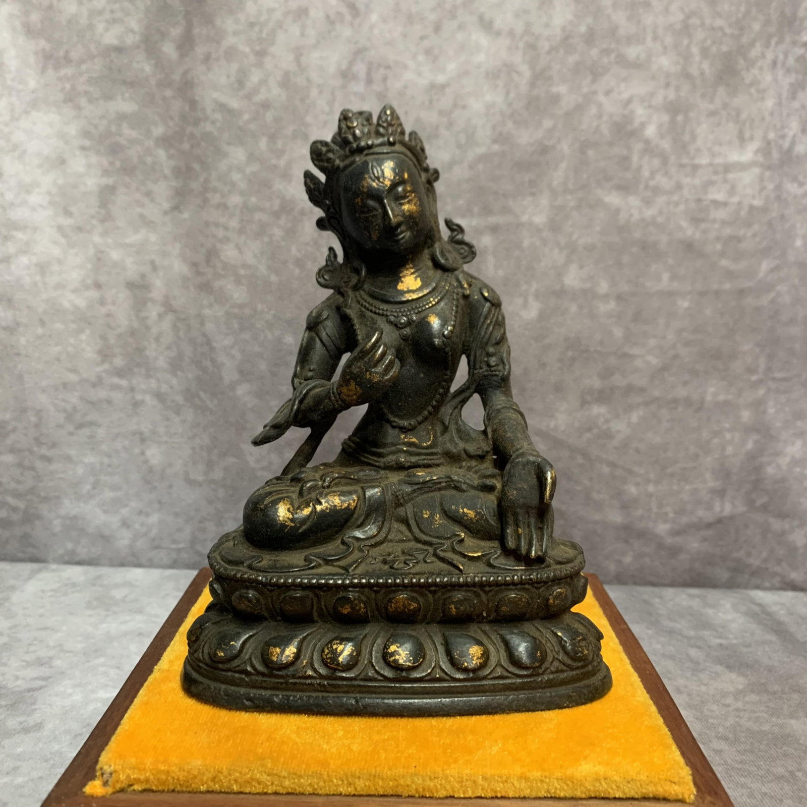 A FINELY CARVED BRONZE FIGURE OF GREEN TARA: 20th Century; High: 6.7 inch; Width: 4.9 inch; Long: 3.0 inch; wooden base for picture and display purpose only.
