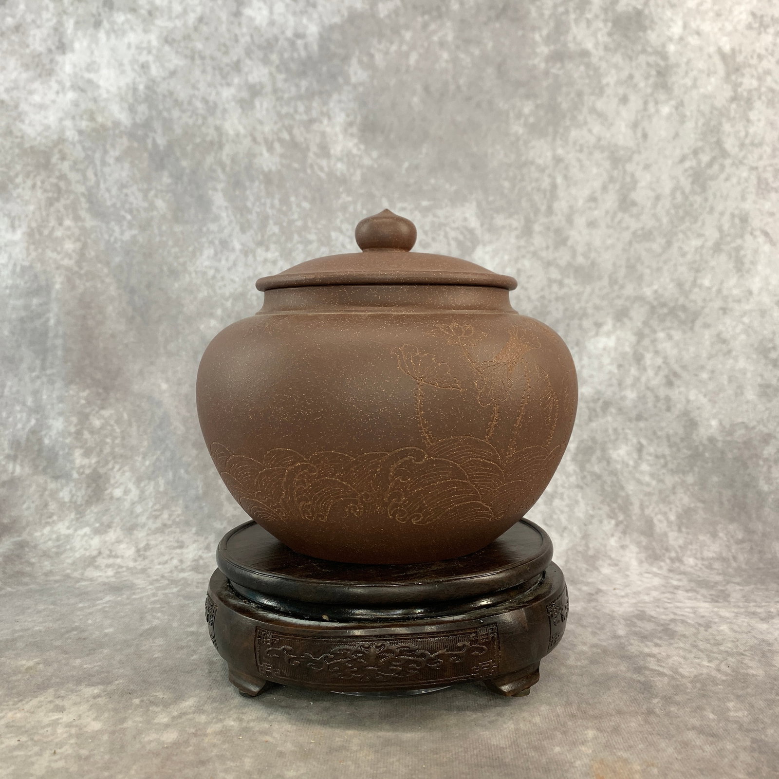 A INCISED YIXING ZISHA COVERED TEA CADDY OR JAR: Modern; High: 6.2 inch; Diameter: 7 inch; Wooden base for picture and display only