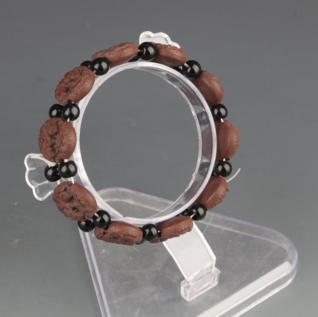 A "FISH" CARVED YIXING ZISHA BRACELETS: 20th Century, D:2.2 in