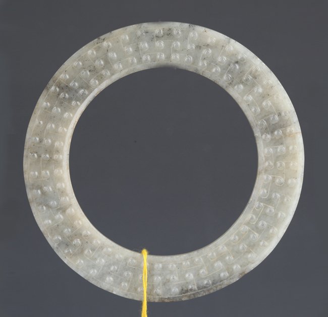A VERY OLD ROUND JADE PLAQUE: Han Dynasty, D:3.6 in