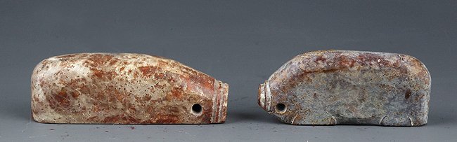 A PAIR OF PIG SHAPED OLD JADE: Han Dynasty, L:2.8in × D:1.1in