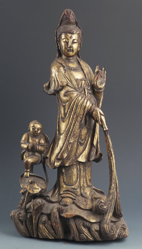 A LARGE CARVED WOOD DECORATION "GUAN YIN SONG ZI" (1 of 9)
