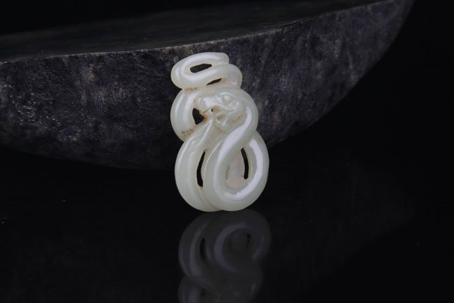 A FINE SNAKE SHAPED PALE CELADON JADE PENDANT (1 of 2)