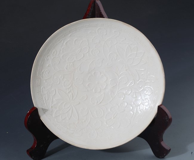 A RARE AND FINELY CARVED PORCELAIN PLATE, "DING YAO" (1 of 4)