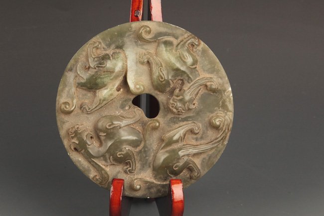 A ROUND AND FINLY CARVED DRAGON PALE CELADON JADE: Possible Ming Dynasty, Diameter: 4.5 inch