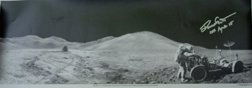 860: Apollo 15 David Scott Autograph: in silver Sharpie on a black and white NASA landscape photograph (23 x 8.5") of Scott on the lunar surface storing core samples on the LM. Modest faults.