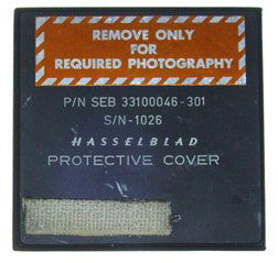 Apollo 15 Hasselblad Cover Used Lunar Surface: This Hasselblad cover ( 3.25 square x .25") was used by David Scott when he changed film packs on the lunar surface during the extended scientific exploration of the Moon conducted on the Apollo 15 Mi