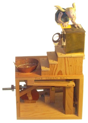 "The Green Ball" #31 Automata: "The Green Ball" #31 Mechanical Automata Signed by Matt Smith (13 x 9 x 4") A wooden and metal automata of a girl doing the wash with a washing machine and a copper wash bin. The green ball is missing