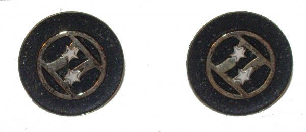 A Pair of Gemini Program Earrings: (.75" diameter) A set of screw-back earrings bearing the Project Gemini logo. The logo is executed in goldtone with white enamel stars. Still in its original box. Good condition.