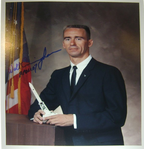 Apollo 7 Astronaut Walter Cunningham Autograph: On an official NASA color publicity photograph (8 x 10") printed on Kodak paper of the astronaut in his business suit. Cunningham has signed in blue Sharpie and inscribed the piece "Walt Cunningham Ap