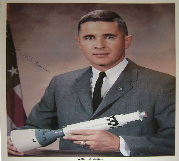 Apollo 8 Astronaut William Anders Autograph: on an official NASA color publicity lithograph (8 x 10") of the astronaut in his business suit. Anders has signed in blue ink. Excellent condition.