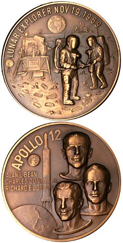 Apollo 12 Medallion: (2.25" diameter) Bronze colored medallion commemorating the Apollo 12 mission. The obverse bears portraits and names of the crew, the reverse a picture of two astronauts and the LM on the lunar surfac