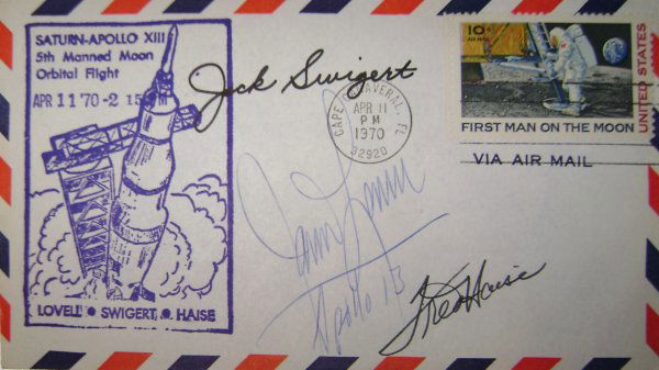Lovell Haise & Swigert Autographs Apollo 13 Cover: the cover bears a US "First Man on the Moon" 10-c stamp tied with Cape Canaveral launch date cancel dated Apr 11, 1970, and magenta rubber-stamped Saturn-Apollo XIII cachet. Signed in blue ink by Jim