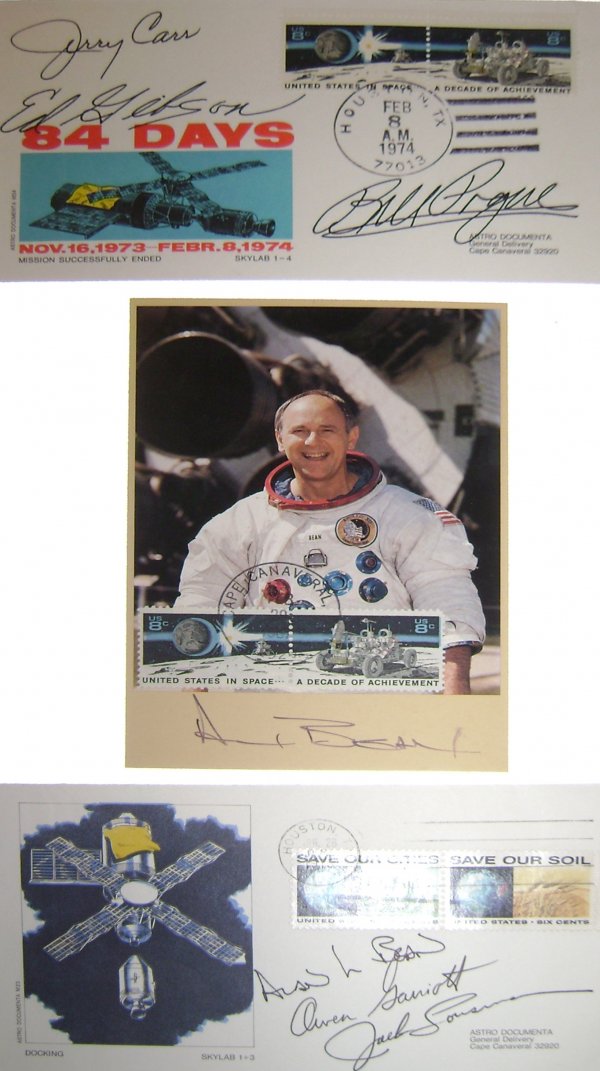 Skylab, Alan Bean Autograph on a Color "VIP Karte": (3.75 x 5.5") which bears two "United States in Space – A Decade of Achievement" 8c US postage stamps and Jerry Carr, Owen Garriott, Jack Lousma autographs in black ink. ALSO included are three auto